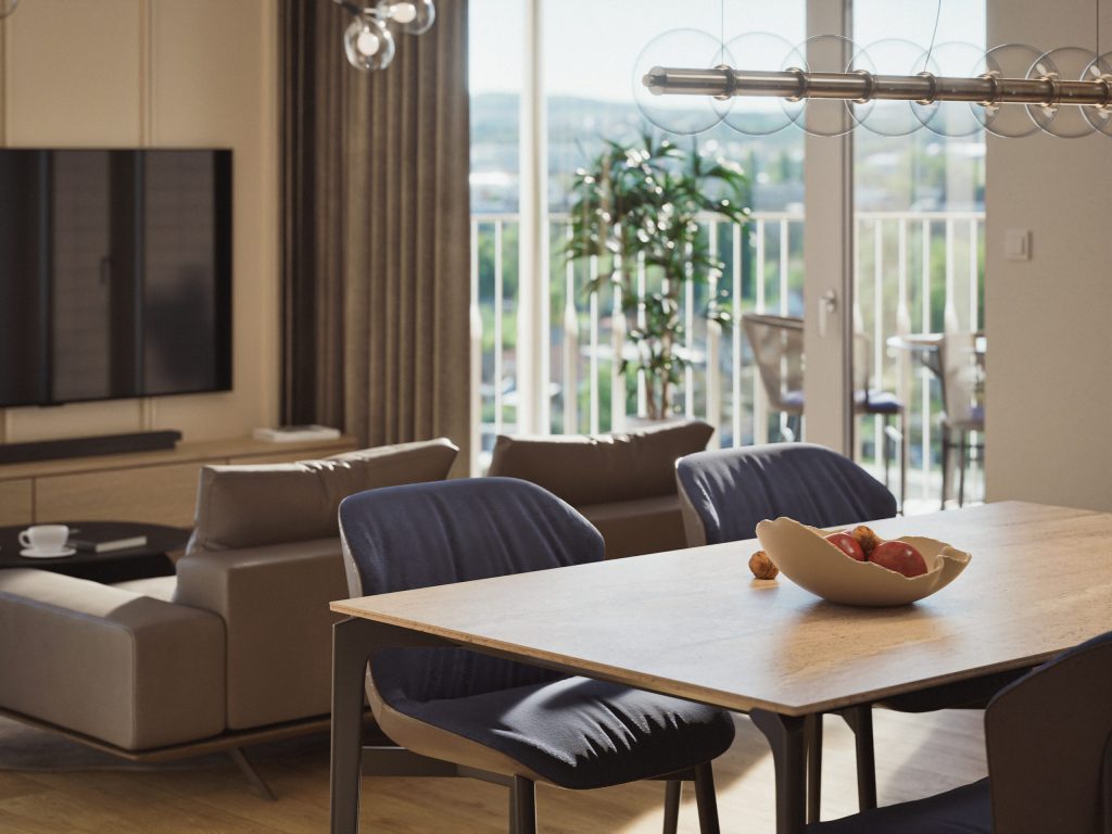 Jídelní stůl s mísou ovoce, za ním obývací pokoj a prosklený vstup na balkon